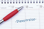 Kalender mit Schrift Dienstreise darauf